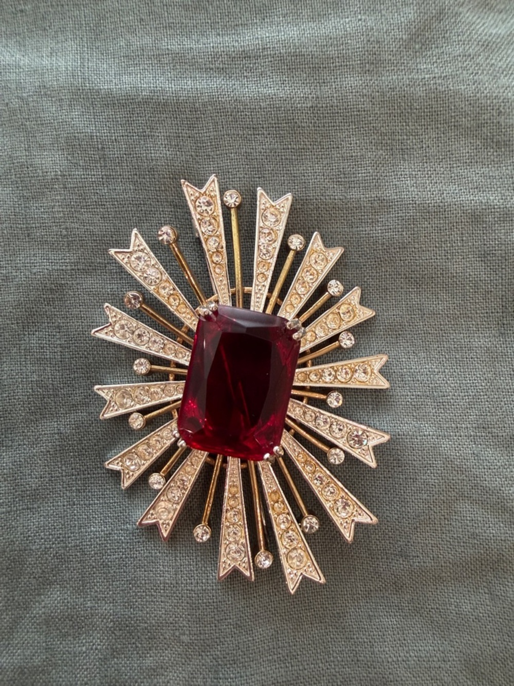 Elegant Vintage Gold-Tone Starburst Brooch with Deep Red Center Stone